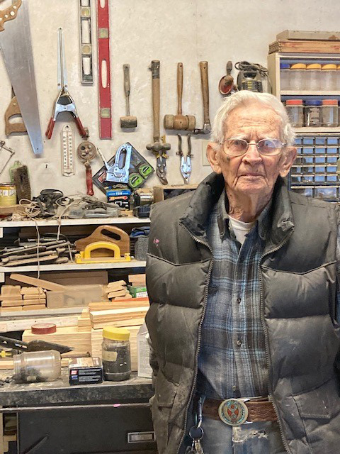 Don M. standing in front of his workshop.