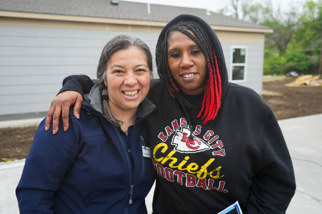 Homeowner services manager Katharine smiling with family partner Shauntae.