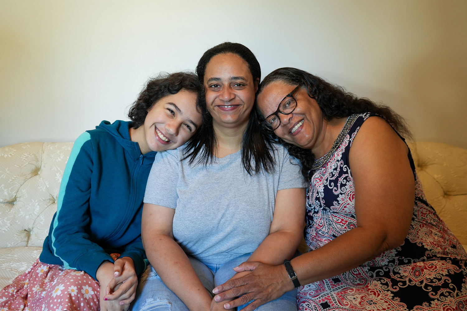 Family partner Lovetta and her family smiling together.