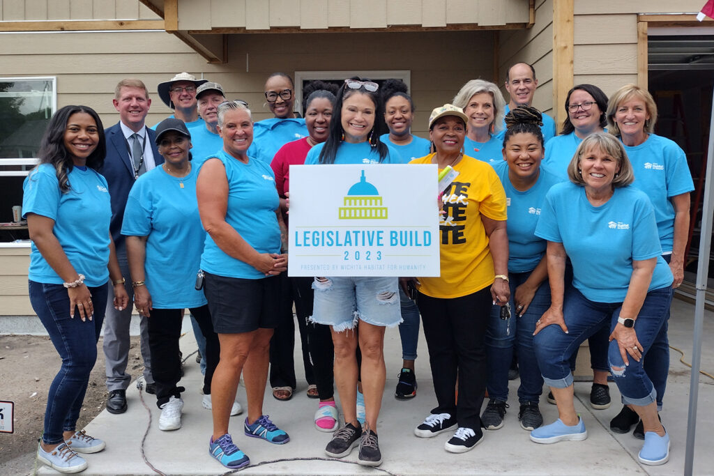 Participants attending Legislative Builc 2023 taking a group photo with a Legislative Build 2023 sign.