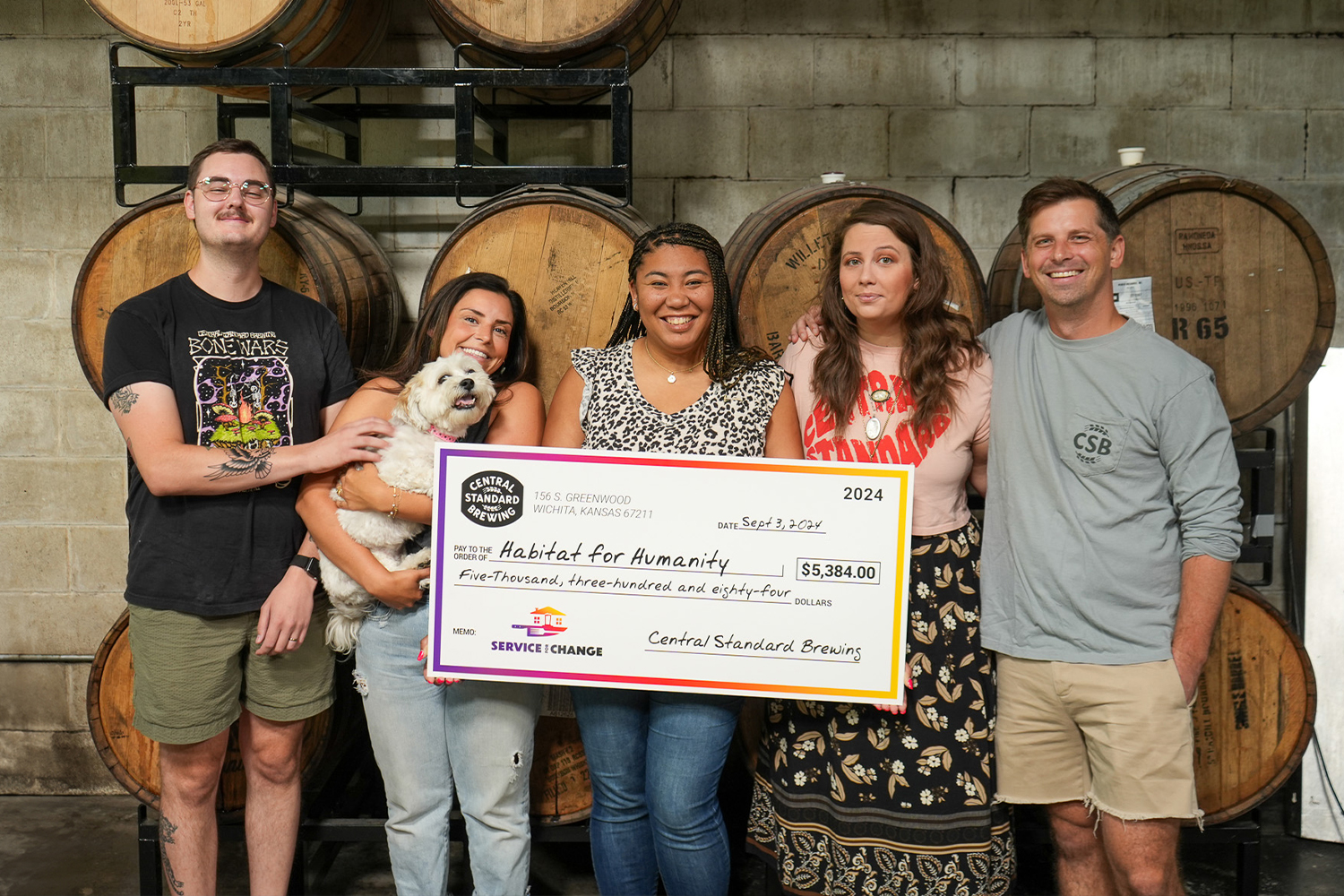 Employees of Central Standard Brewing presenting a check to Wichita Habitat for Humanity.