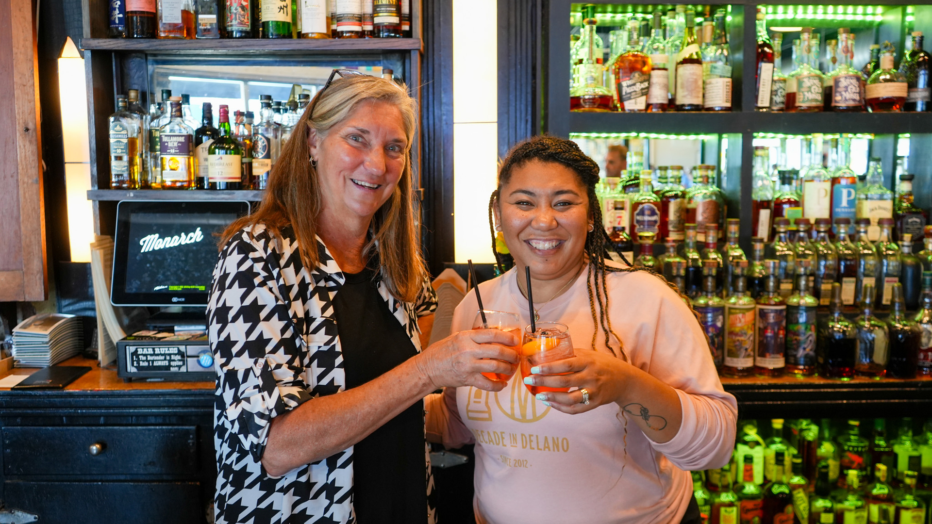 Ann Fox and Danielle Johnson clinking their glass of sangria together.