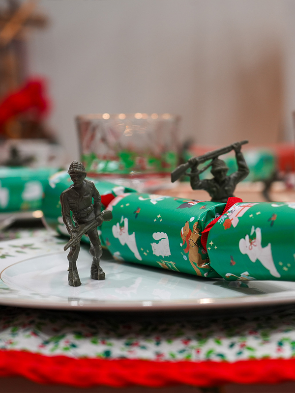 Toy soldiers displayed on vintage china.