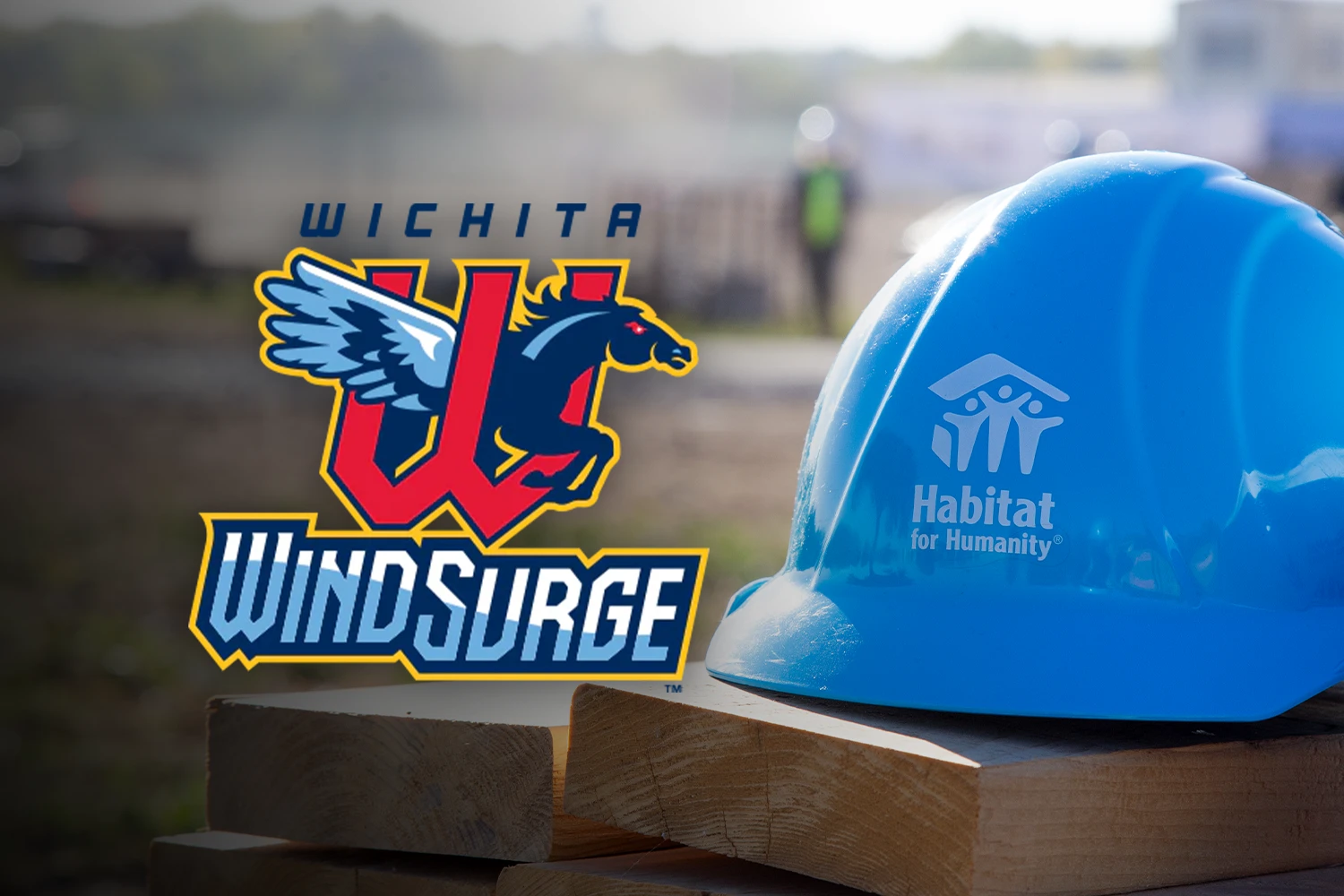 A blue hard hat with the Habitat logo sitting on two wooden studs and a floating Wind Surge logo.
