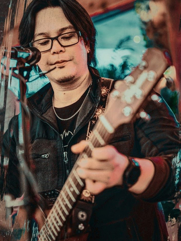 Musician Patz performing with his guitar.