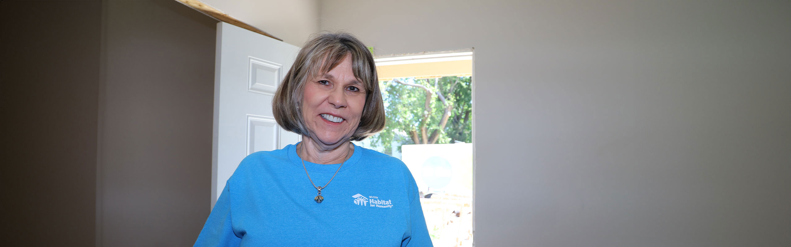 Ann Patterson standing inside of a home under construction.