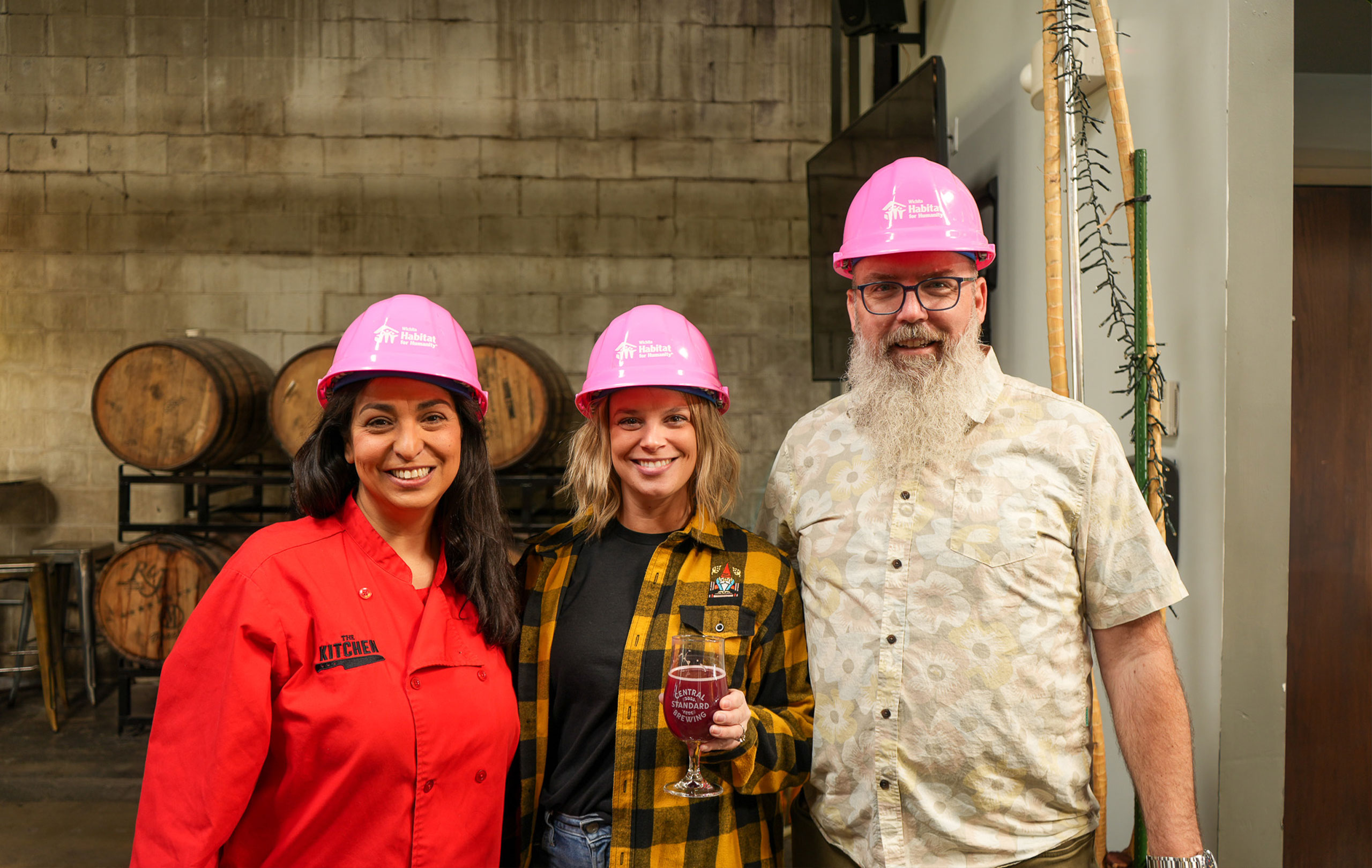 Three attendees from Lunacorn Brew smiling together.