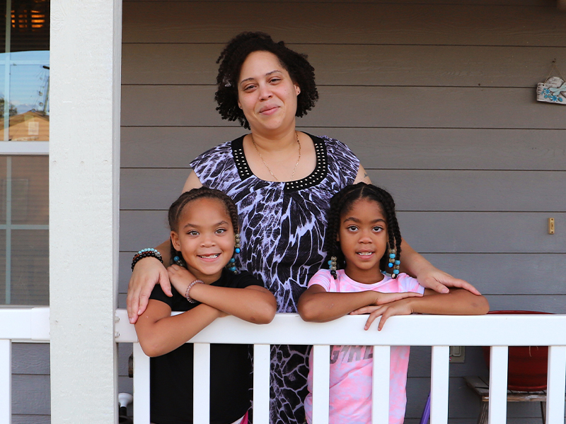 A family partner standing on their porch.