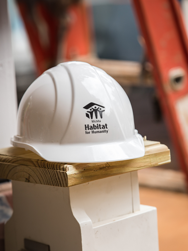 A hard hat sitting on a ledge.