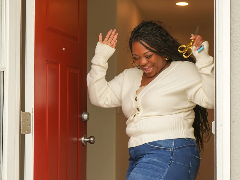 Family partner Victoria celebrating as she receives the keys to her home.