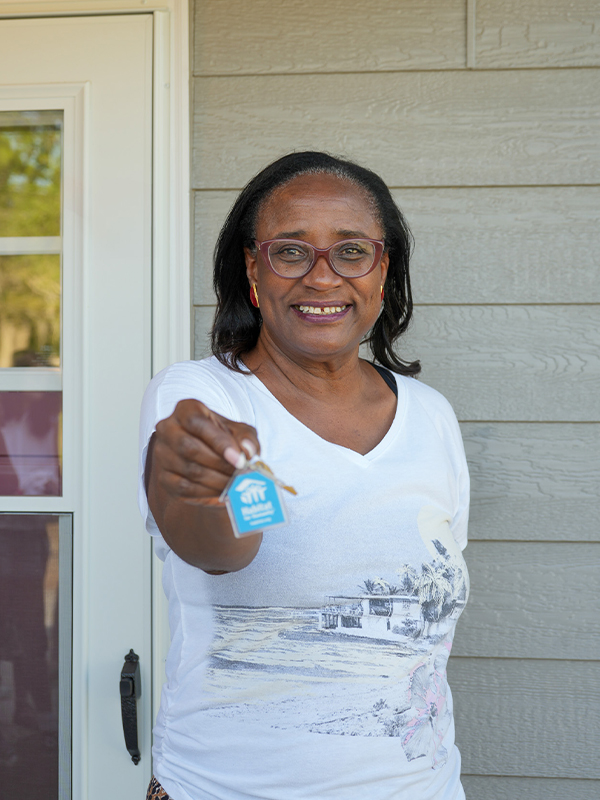 Family partner receives keys to new home.