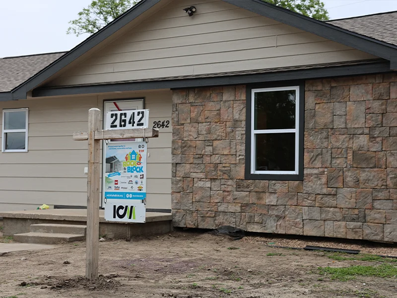 A Rock the Block and ICM sign posted in front of a home.