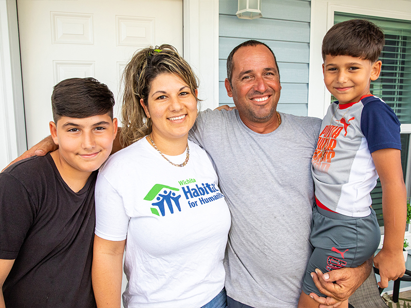 Habitat family partners smiling together.