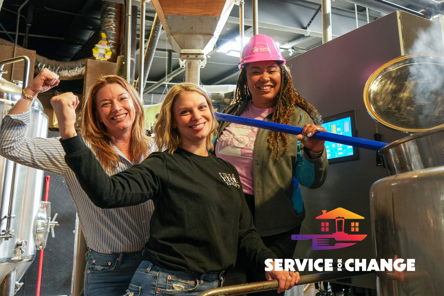 Jennifer, Stacy, and Danielle posing together next to a brewing machine with Service for Change logo.