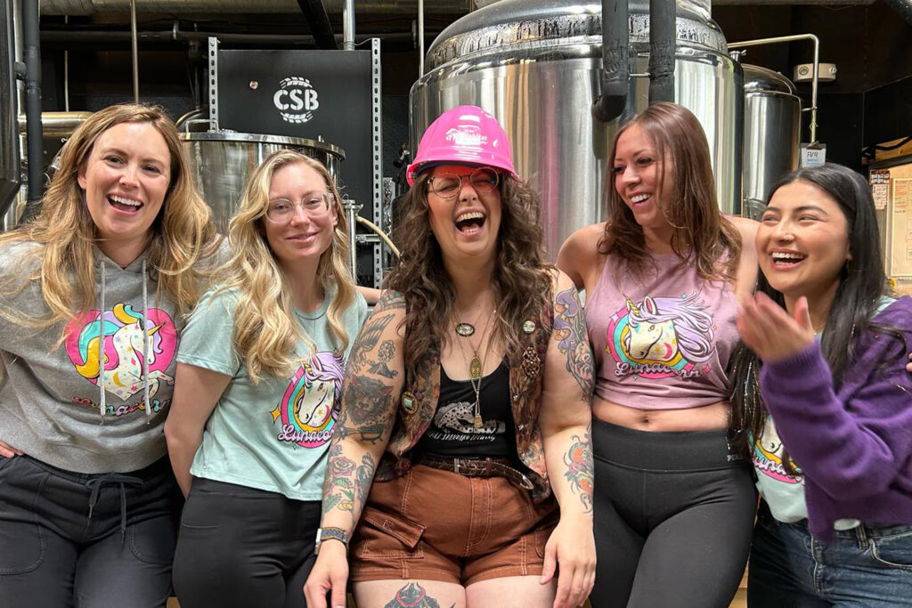 Employees at Central Standard Brewing smiling and laughing together.
